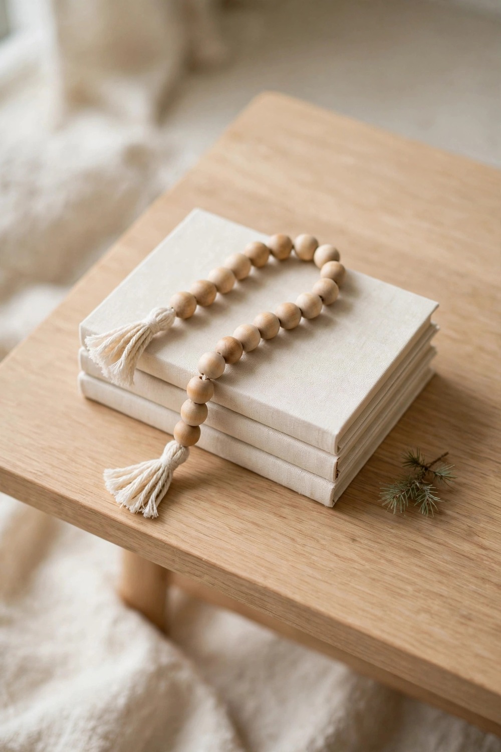 Minimalist Christmas decor: wooden bead garland with tassels on a coffee table vignette